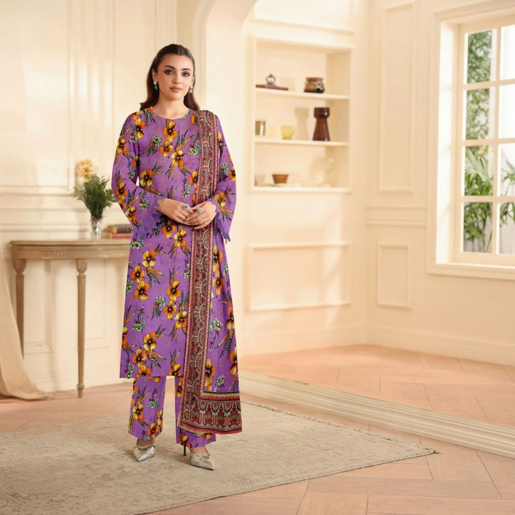 Woman in a purple floral outfit standing in a well-lit room with a bookshelf in the background.