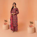 Woman in a floral dress standing against an orange background with decorative elements.