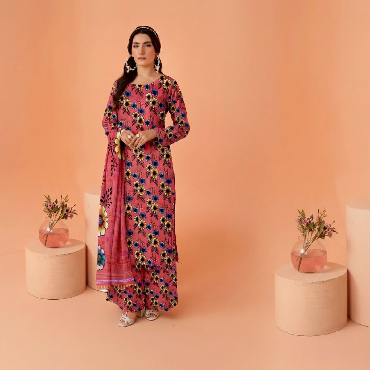 Woman in a floral dress standing against an orange background with decorative elements.