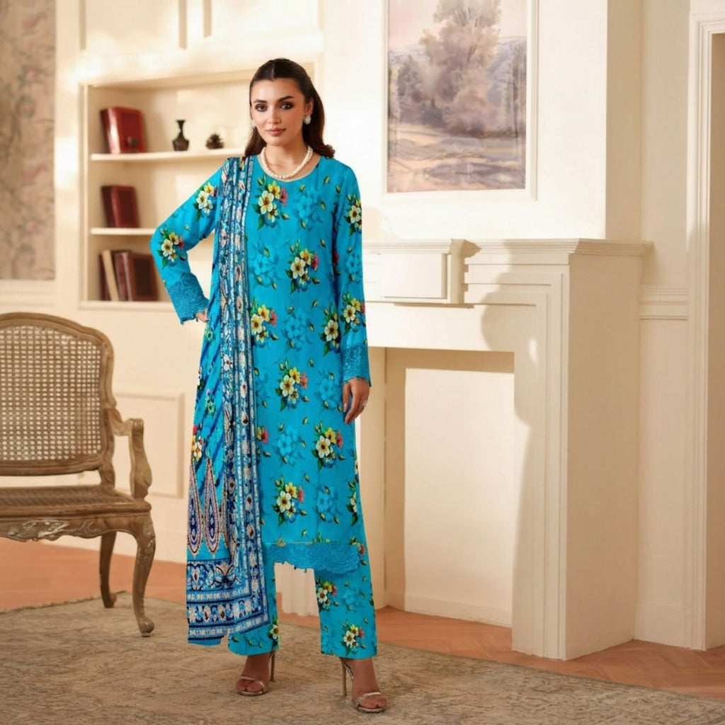 Woman in a blue floral traditional outfit standing in a room with a fireplace and chair.